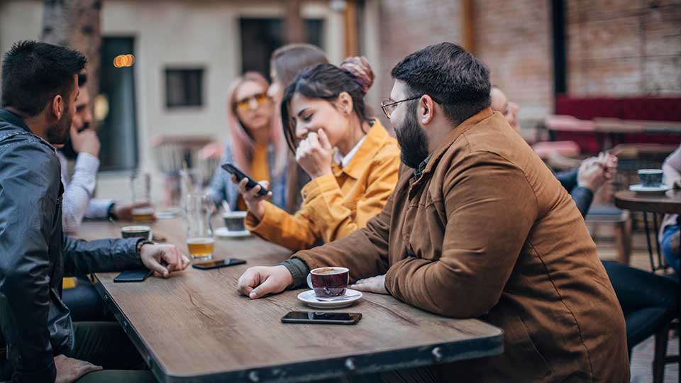 image of people drinking beer around a table