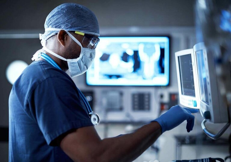 A doctor touching a screen