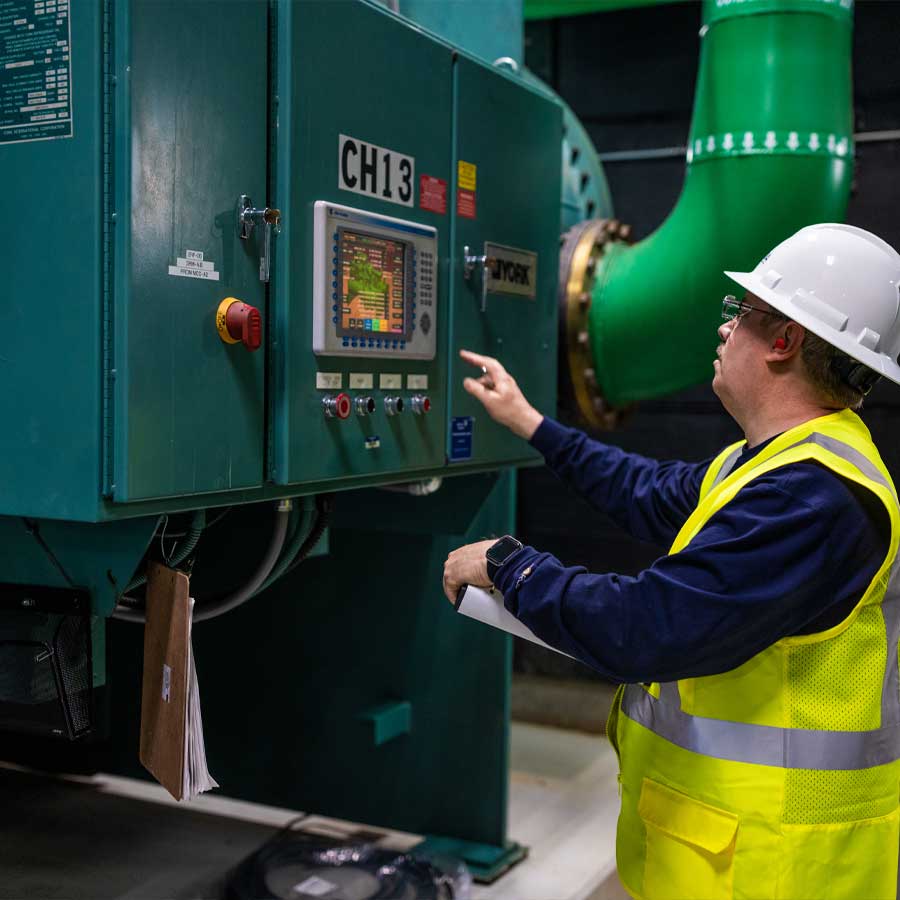 worker pushing buttons on a machine